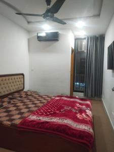 a bed in a room with a ceiling fan at Silver Arc Plaza in Islamabad
