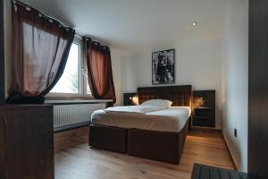 a small bedroom with a bed and a window at Hotel Restaurant Latio in Cologne
