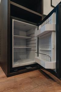 an empty refrigerator with its door open in a kitchen at Hotel Restaurant Latio in Cologne