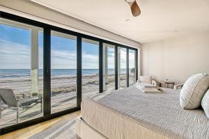 a bedroom with a bed and a view of the beach at GP58: 58 Grand Pavilion in Isle of Palms
