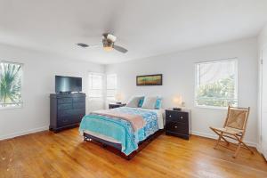 En eller flere senge i et værelse på Sunsetter on Sapphire Shores