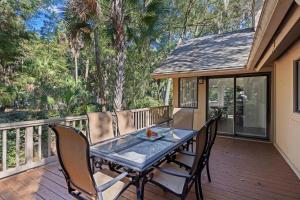 a patio with a table and chairs on a deck at SI2995: 2995 Seabrook Island Rd. in Seabrook Island