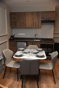a table with plates and glasses on it in a kitchen at Suite Bahiya 11 in Fès