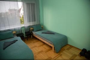 a room with two beds and a window at Azimut Guest House Self Check-in in Šiauliai
