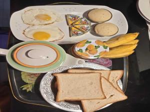 a tray of breakfast food with eggs and toast at Princess Villa Kandy Rail Station in Kandy