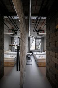 a room with a bunch of beds in it at Hotel Aréna in Jihlava