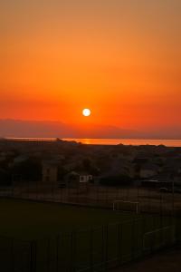 a sunset over the ocean with the sun setting at Sumqayıt Bulvar in Sumqayyt