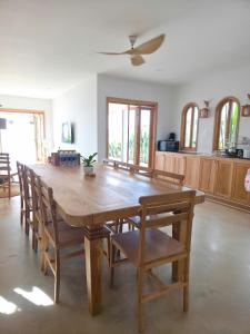 a dining room with a wooden table and chairs at Villa Biển Vàng Beach Front in Bình Sum +23 photos
