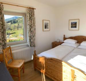 een slaapkamer met twee bedden en een groot raam bij Haus Werner in Ramsau am Dachstein