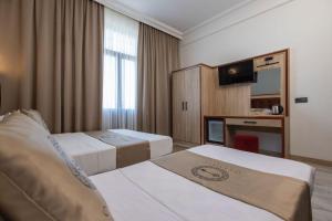 Postel nebo postele na pokoji v ubytování Olimpic Hotel