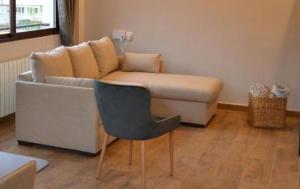 a living room with a couch and a chair at Ático con terraza y vistas únicas a la Catedral in Granada +2 photos