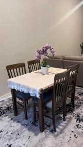 a table with two chairs and a potted plant on it at POOL CaSSa Ardina pantai Batu hitam 4rooms in Kuantan +6 photos