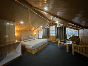 a bedroom with a bed in a wooden room at The Woodpecker Inn Jibhi in Jibhi