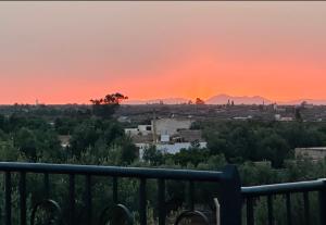 a view of a city at sunset at Lily Manzil in Ain Cheggag