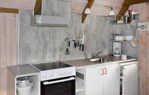 a kitchen with a sink and a stove at Stunning Home In Hanstholm With Private Swimming Pool, Can Be Inside Or Outside in Pugdal