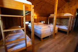 a room with four bunk beds in a cabin at Laugarfell Accommodation & Hot Springs in Laugarfell +12 photos