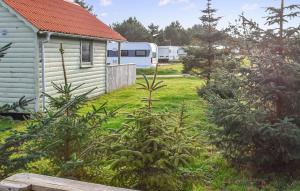 a yard with a house and trees and a trailer at Stunning Home In Hanstholm With Private Swimming Pool, Can Be Inside Or Outside in Pugdal +22 photos