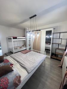 a bedroom with a large bed and a chandelier at -Self-Check- Luxury view penthouse on the roof of City in Nitra