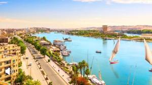 a view of a river with boats in a city at Garden view in Aswan