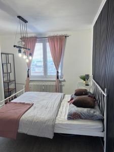 a bedroom with a bed with pillows and a window at -Self-Check- Luxury view penthouse on the roof of City in Nitra
