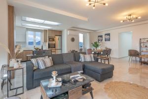 a living room with a couch and a table at Athena Home South Crete in Kapparianá