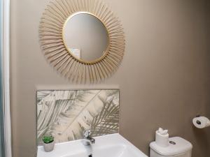 a bathroom with a mirror above a sink at Apartment 2, Blackburn Heights in Bridlington +23 photos