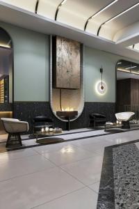 een lobby met stoelen en een tv aan de muur bij Le Méridien Toronto Pinnacle Hotel in Toronto