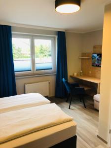 Postel nebo postele na pokoji v ubytování Gästehaus am Elberadweg by Hotel Alte Fischerkate