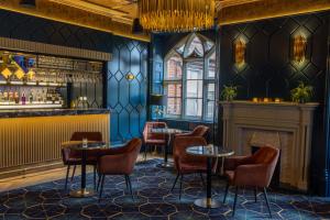 een restaurant met tafels en stoelen en een open haard bij Best Western Abbots Barton Hotel in Canterbury