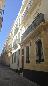 a row of buildings on a city street at El Tesoro de Cadiz in Cádiz