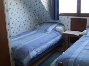 une petite chambre avec deux lits et une fenêtre dans l'établissement Maison Gwel Kaer, à Perros-Guirec