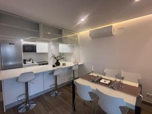 a kitchen with a counter and a table and chairs at The luxury suite in Alicante