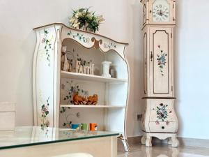 eine Kommode und eine Großvater-Uhr in einem Zimmer in der Unterkunft 7BR Penang Stay Near Gurney and George Town in Tanjong Tokong