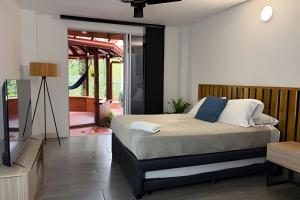 a bedroom with a bed and a television at Palos altos house Poblado 6 min to Provenza in El Poblado +37 photos
