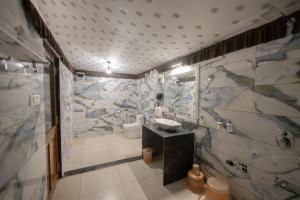 a bathroom with a sink and a toilet and a shower at Vasant Vihar Resort in Kevadia +66 photos
