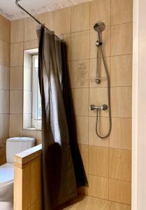 a shower with a black shower curtain in a bathroom at Domek Aga in Węgorzewo