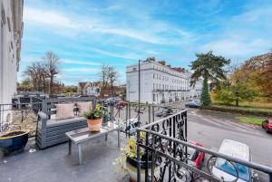 a balcony with a couch and bikes on a city street at Spacious Apartment with Balcony, Clarendon Square in Leamington Spa
