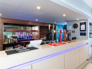 a bar with a counter with drinks on it at Holiday Inn Express London Greenwich by IHG in London