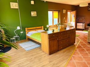 a bedroom with a bed and a green wall at GreenPark Candy Manor with Large Garden Close to Tokaj in Bekecs
