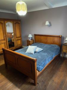 a bedroom with a wooden bed with two pillows on it at Relais Ganderats in Came