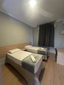 Ένα ή περισσότερα κρεβάτια σε δωμάτιο στο Unity Hotel - Santos