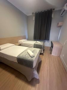 Ένα ή περισσότερα κρεβάτια σε δωμάτιο στο Unity Hotel - Santos +21 φωτογραφίες