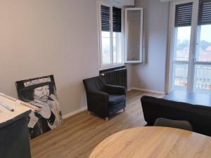 a living room with a table and a chair at saffi15 in Sannazzaro deʼ Burgondi