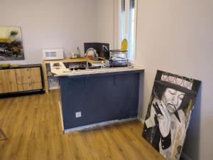 a kitchen with a counter with a painting of a man at saffi15 in Sannazzaro deʼ Burgondi