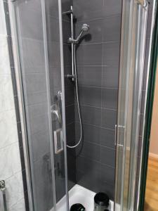 a bathroom with a shower with a glass door at saffi15 in Sannazzaro deʼ Burgondi