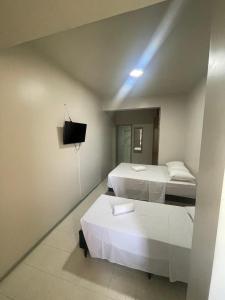 a room with two beds and a tv on the wall at Prestige Manaus Hotel in Manaus +20 photos