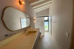 a bathroom with a large mirror and a sink at Apto BR Suites 6 min de Provenza, encanto natural in Medellín +21 photos
