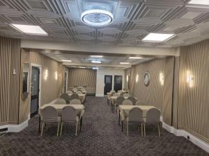 a room with rows of tables and chairs in it at MARS Hotel Seaview Blackpool in Blackpool
