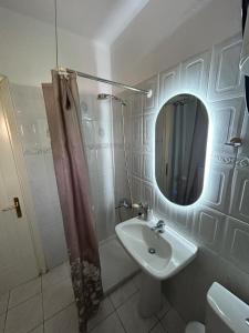 a bathroom with a sink and a shower and a mirror at Villa in Ptolemaida in Proástion +41 photos