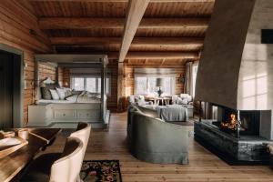 a living room with a fireplace and a bedroom at Storfjord Hotel in Skodje